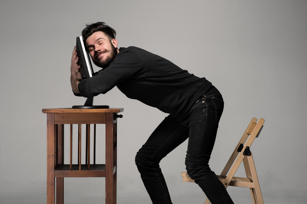 Man hugging a computer.