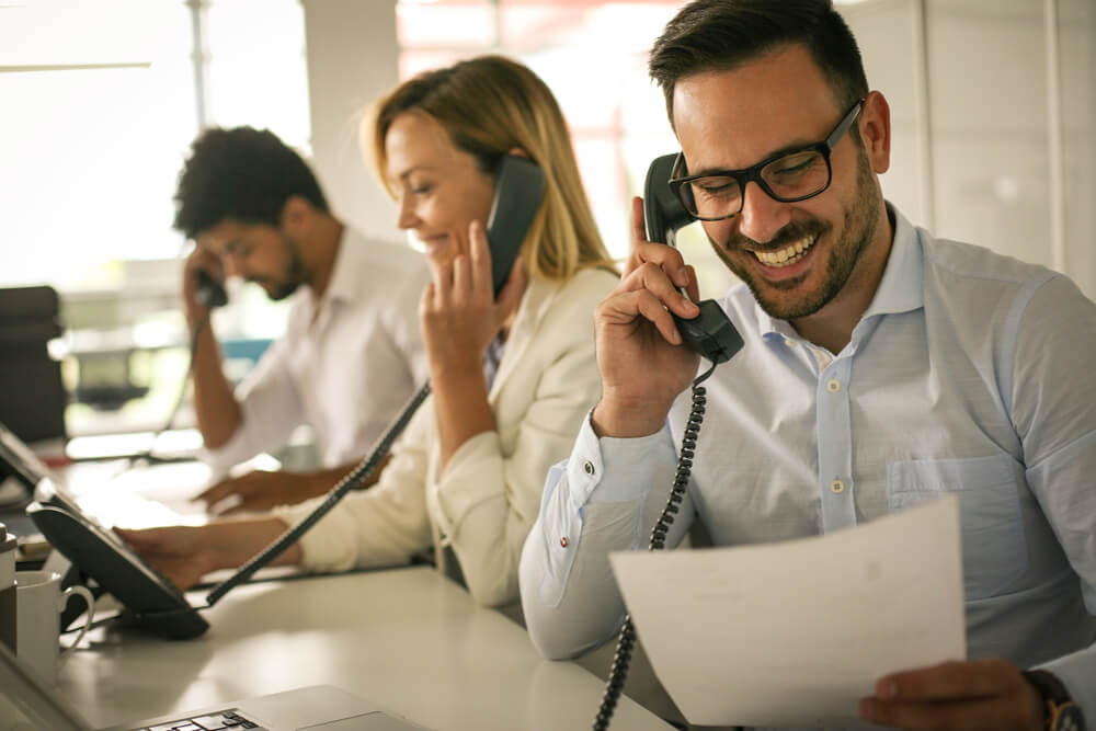 Happy people answering phones.